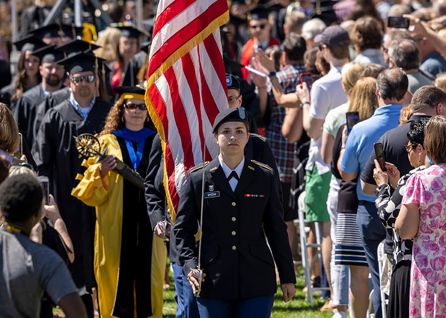 A military science student leads the Commencement procession. 