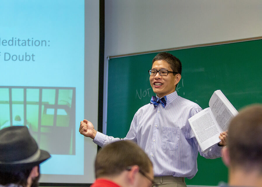 Philosophy professor speaks in front of classroom