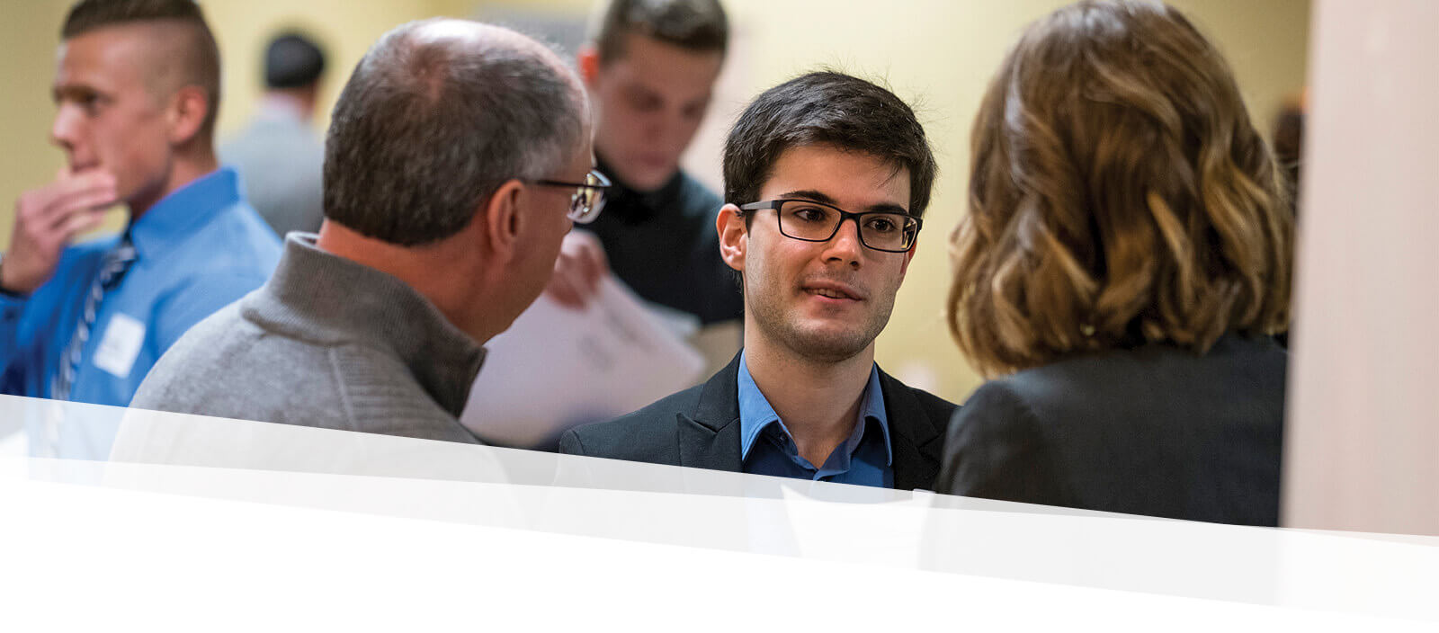 Student talks to prospective employers at a career fair on campus 