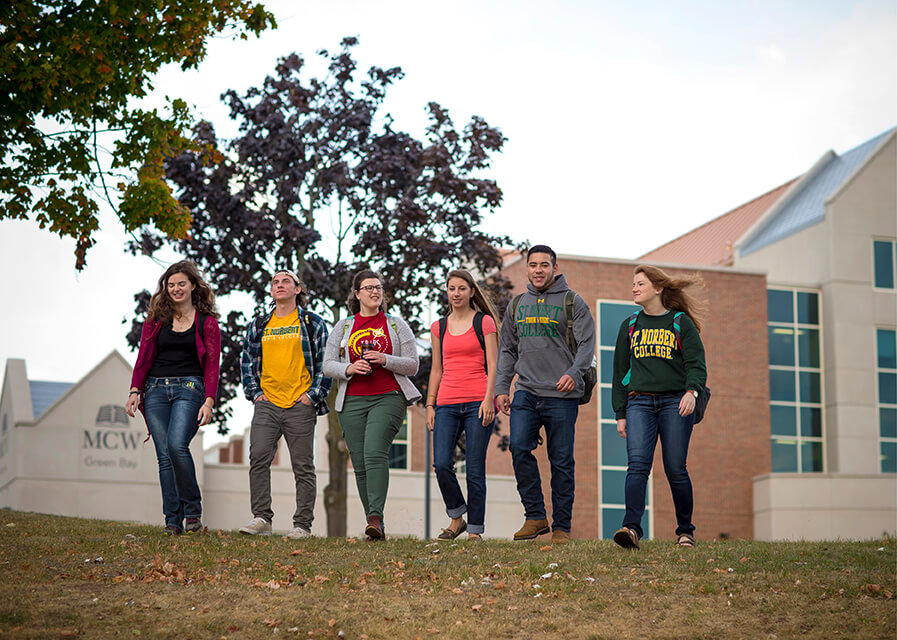 Students walk outside in front of the Medical College of Wisconsin-Green Bay building on SNC's campus