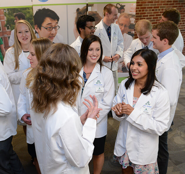 A group of Medical College of Wisconsin students talk to one another.