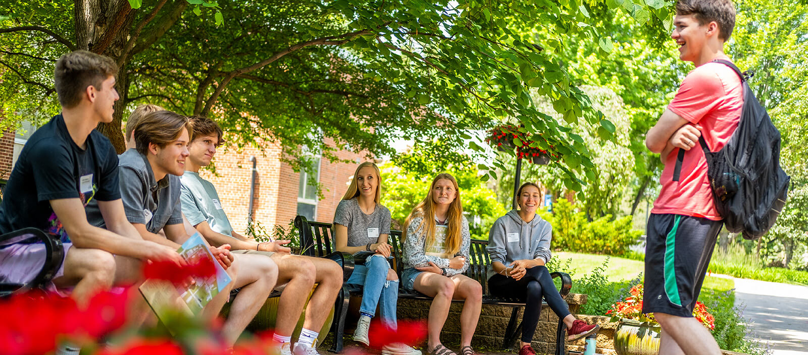 Students talk in a circle outside on campus