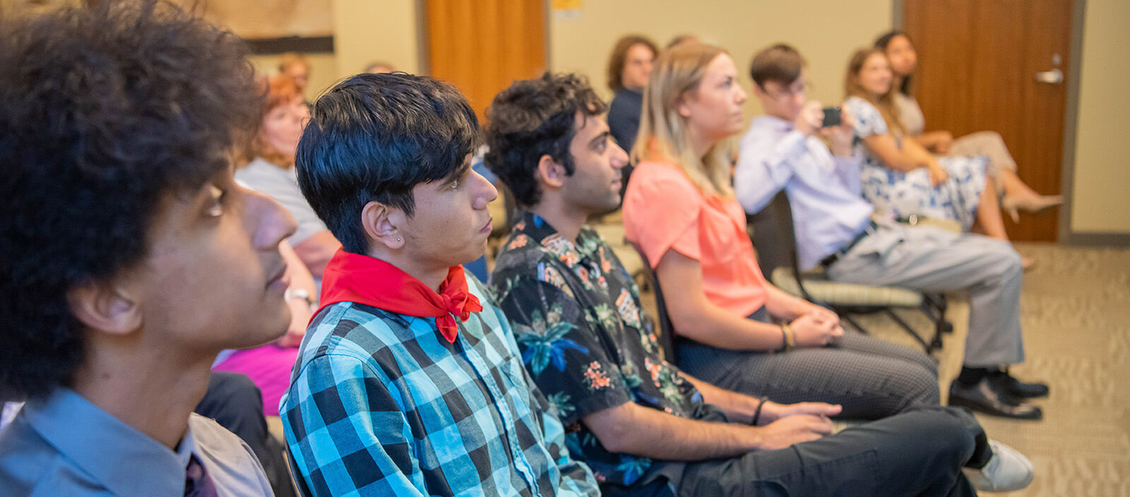 Students listen to a presentation while in class.