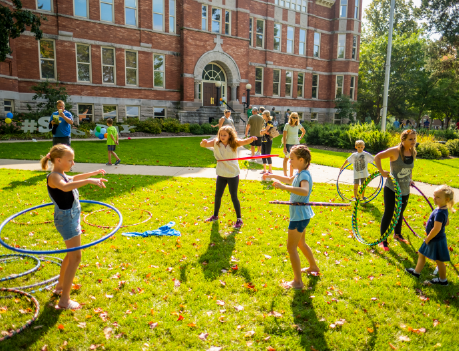 Family hoola-hooping outside of Main Hall