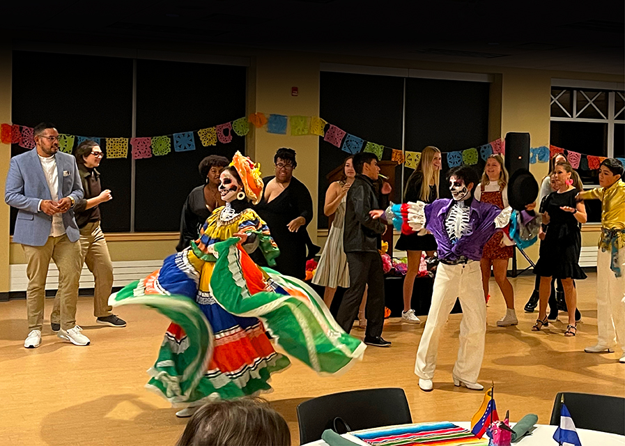 Multicultural students displaying cultural dance 