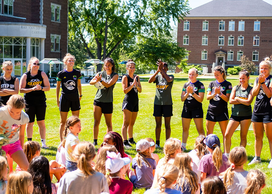 Students work with a group of kids at the SNC campus.