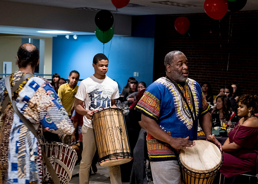 Multicultural students displaying cultural dance 