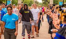 Students walk down Baer Mall for the annual Convocation ceremony
