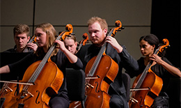 Students playing the cello in concert