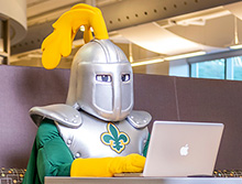 Norby types on a laptop computer