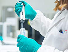 scientist uses a pipette in a lab