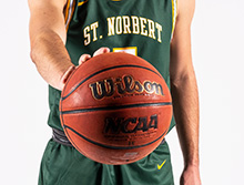 Men's basketball player palms a basketball