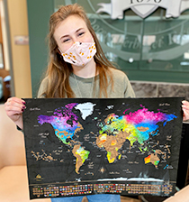 Emily Dehmer ’21 holds up her scratch-off world map