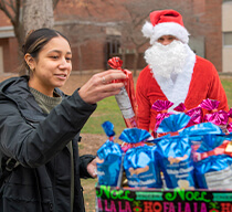Joe Webb dressed up as Santa passes out treats to students
