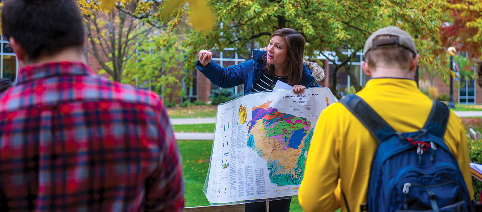 Professor Rebecca McKean teaching students outdoors on the quad.