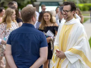 A member of the Norbertine community talking to students