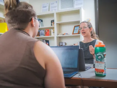 Assistant Professor of Sociology Laura Krull talks with a student