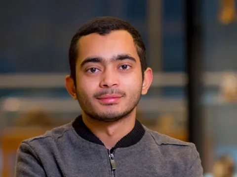 Male student posed in front of a biology lab