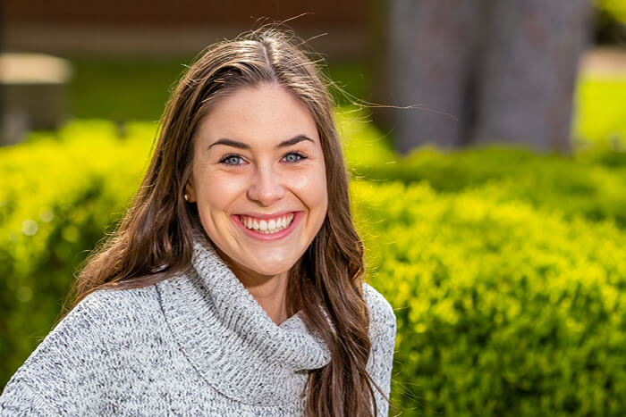 Sara Allaire portrait in the Shakespeare Garden on campus